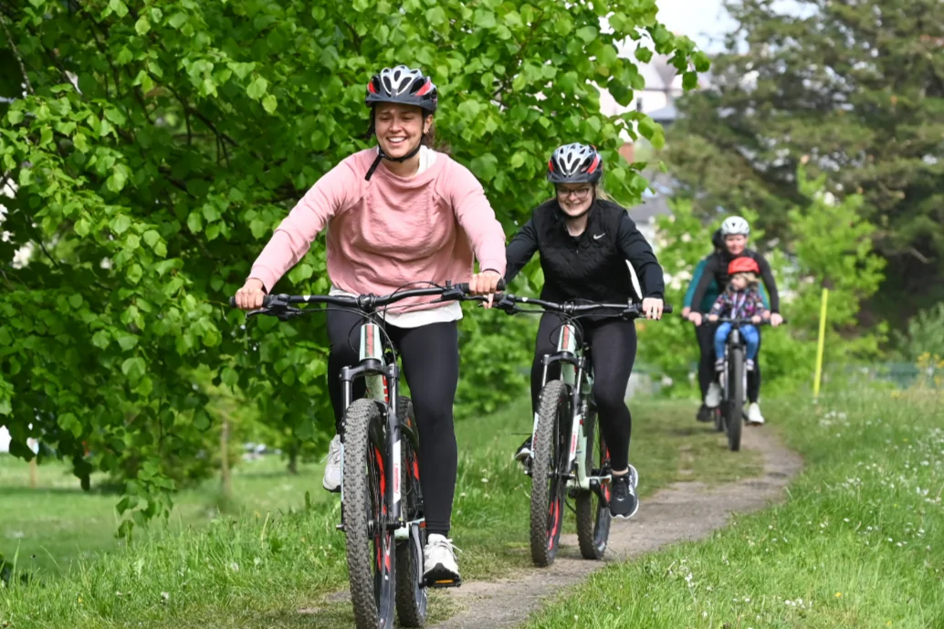 In the photo there are people riding bicycles